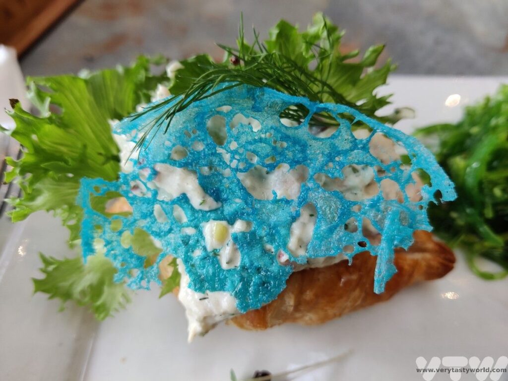 Greenlandic tapas - seafood coissant with blue tuile that looks like an iceberg
