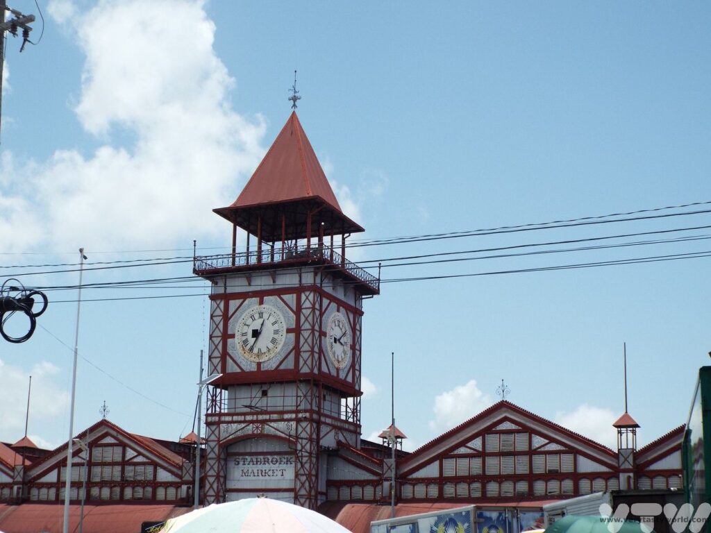 Starbroek Market building with clock. The clock faces are showing different times