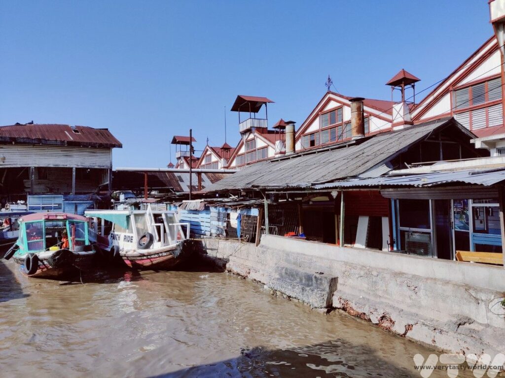 Two boats on the quayside of the market building