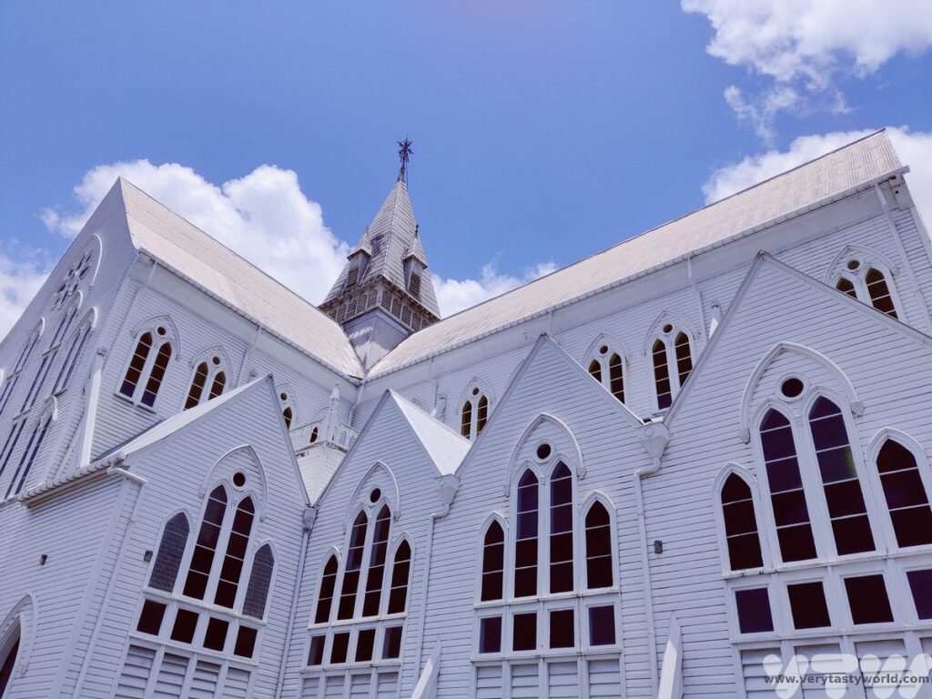 St George's cathedral in Georgetown a large white wooden structure with a tower